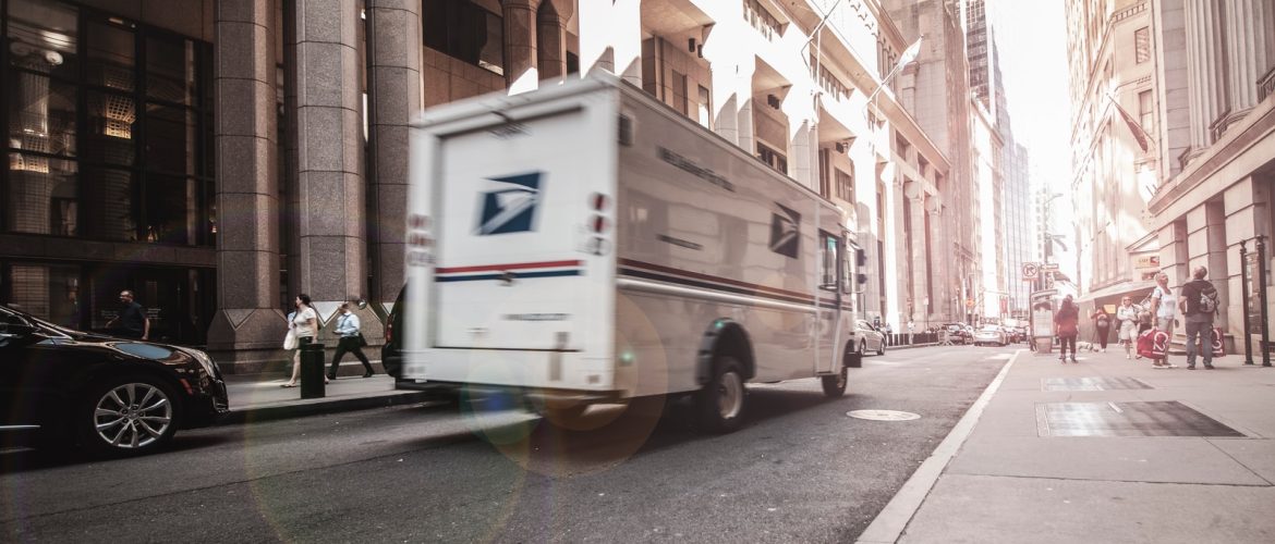 white van parked beside brown concrete building during daytime