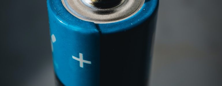 blue and black can on black surface